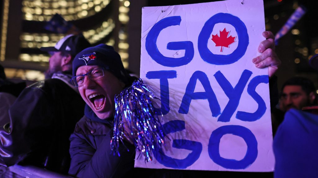 A fan cheers outside Toronto City Hall during Game Seven of the 2025 World Series presented by Capital One between the Los Angeles Dodgers and the Toronto Blue Jays at Nathan Phillips Square on Saturday, November 1, 2025 in Toronto, Canada. (Photo by Kevin Raposo/MLB Photos via Getty Images)