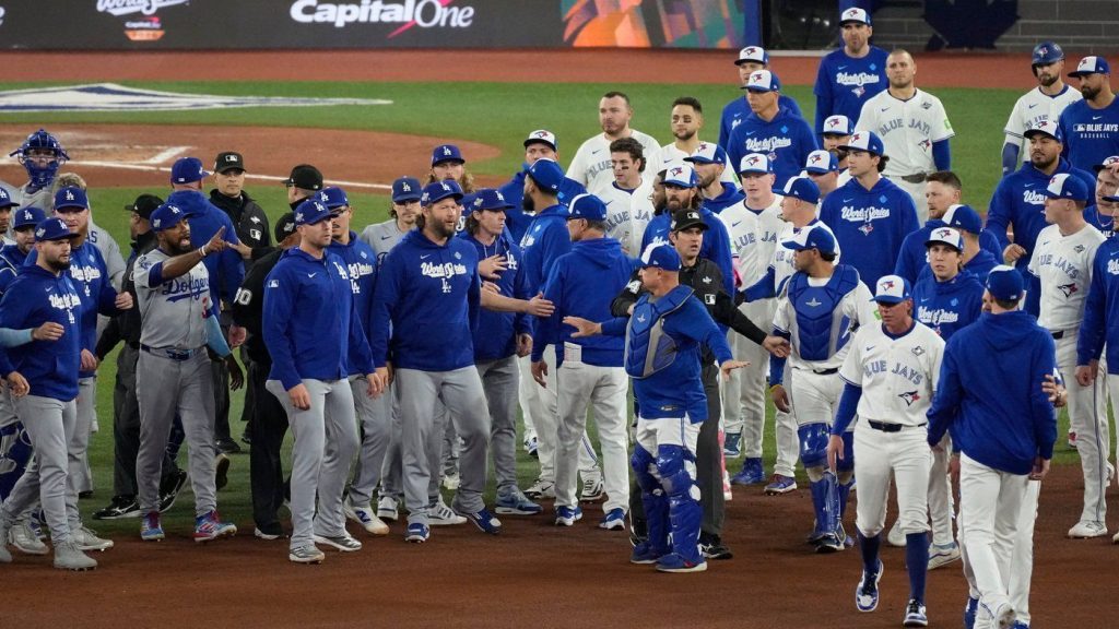 The Los Angeles Dodgers and the Toronto Blue Jays benches clear after Blue Jays' Andrés Giménez was hit by a pitch during the fourth inning in Game 7 of baseball's World Series, Saturday, Nov. 1, 2025, in Toronto. (AP Photo/Ashley Landis)