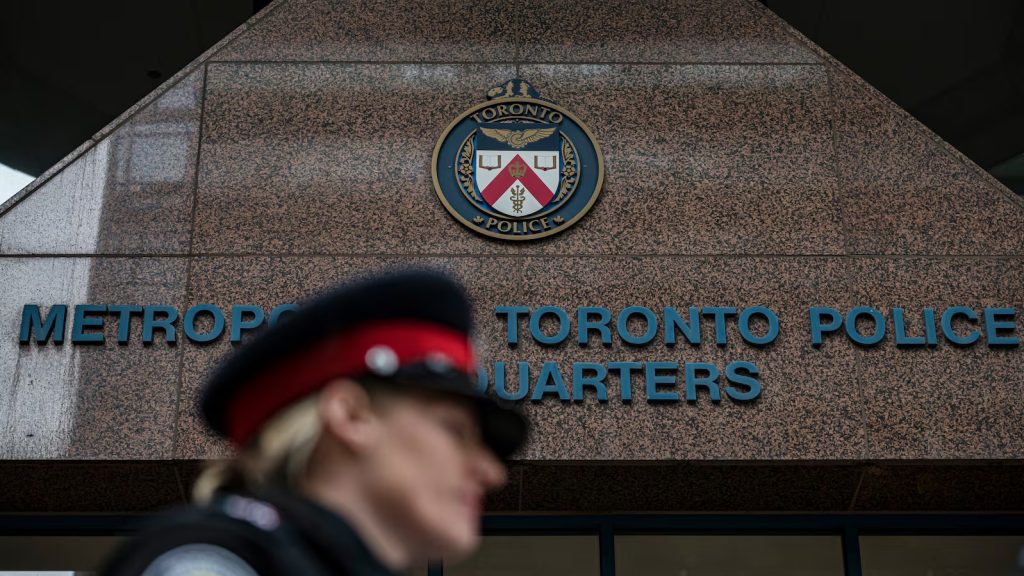 A Toronto police officer is seen outside police headquarters in downtown Toronto in this undated photo. THE CANADIAN PRESS/Christopher Katsarov