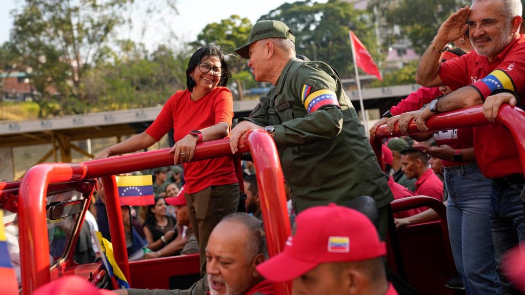 FILE - Vice President Delcy Rodriguez, left, smiles at Venezuelan Defense Minister Padrino Lopez, as they take the route that the body of late President Hugo Chavez was transported to his final resting place, during the activities marking the 10th anniversary of Chavez's death, in Caracas, Venezuela, March 15, 2023. (AP Photo/Matias Delacroix, File)