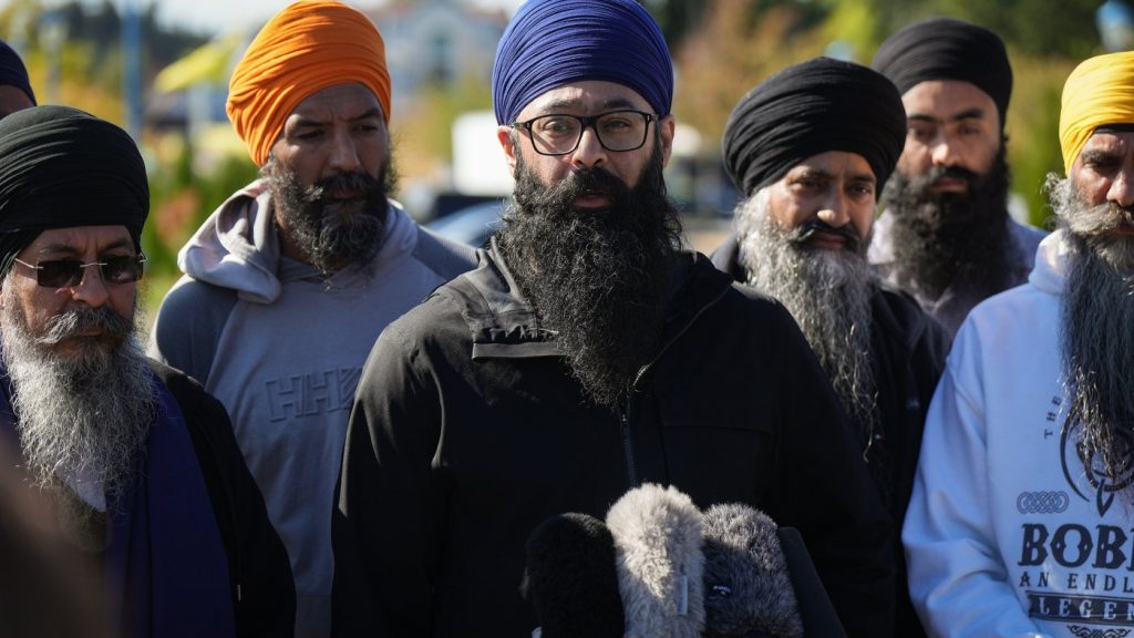 Moninder Singh, centre, a spokesperson for the British Columbia Gurdwaras Council (BCGC), speaks to reporters outside the Guru Nanak Sikh Gurdwara Sahib in Surrey, B.C., on Monday, September 18, 2023, where temple president Hardeep Singh Nijjar was gunned down in his vehicle while leaving the parking lot. THE CANADIAN PRESS/Darryl Dyck
