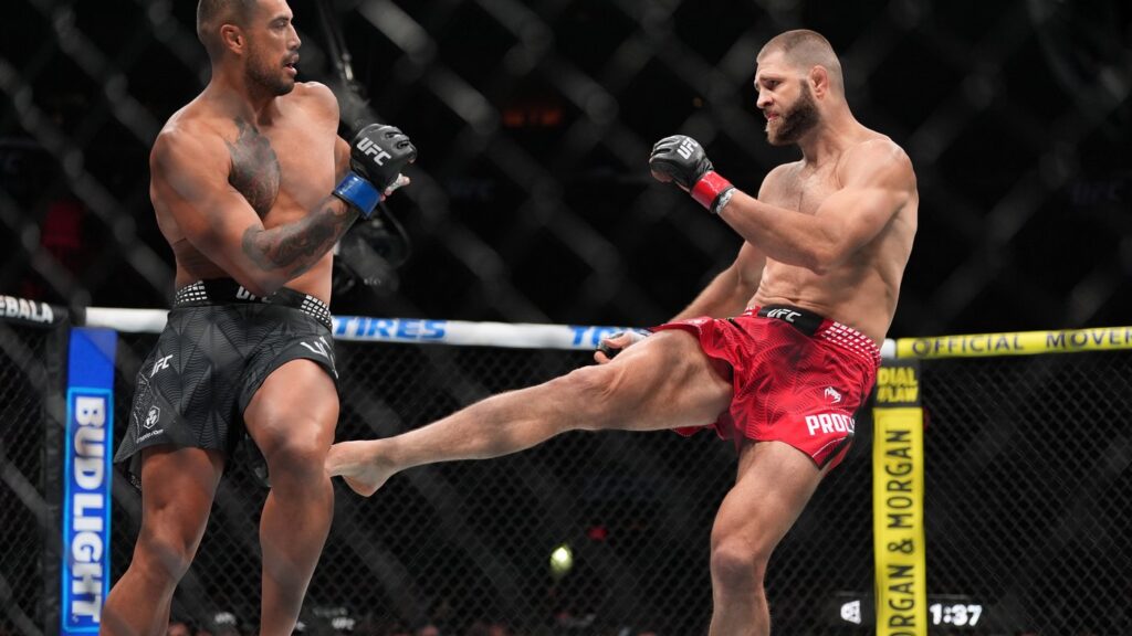 Carlos Ulberg, left, of New Zealand, fights with Jiri Prochazka, of Czechia, in their light heavyweight title bout at a UFC 327 mixed martial arts event, Saturday, April 11, 2026, in Miami. (AP Photo/Rebecca Blackwell)