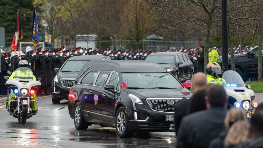 The funeral procession arrives at a funeral service for Ontario Provincial Police Sgt. Brandon Malcolm at the Cobourg Community Centre in Cobourg, Ont.