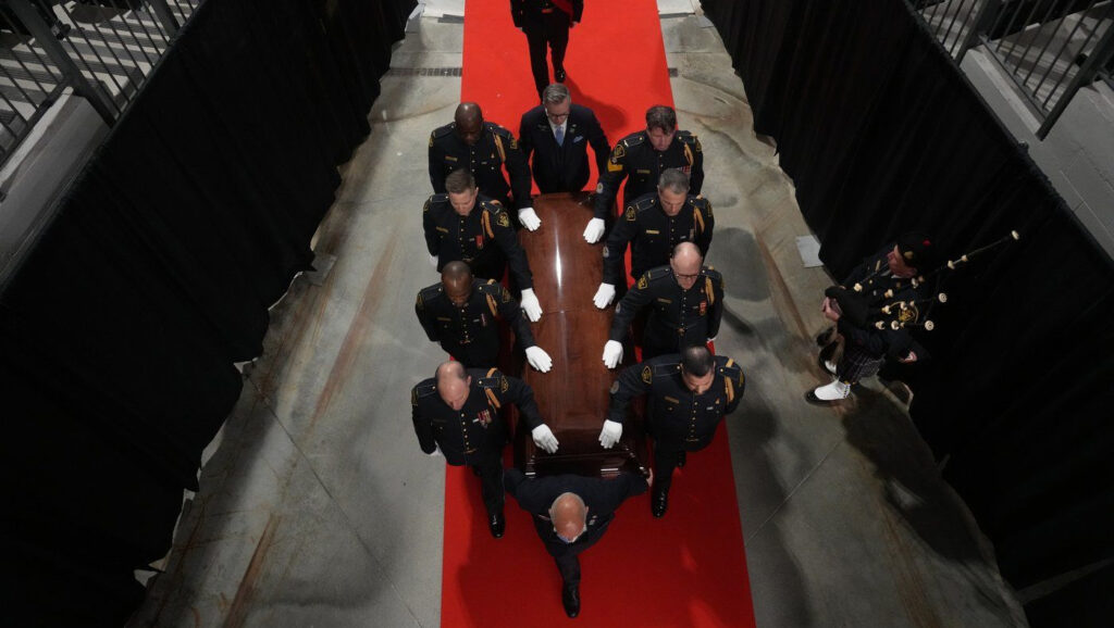 Police officers carry Ontario Provincial Police officer Sgt. Brandon Malcolm's casket during his funeral service in Coburg, Ont.