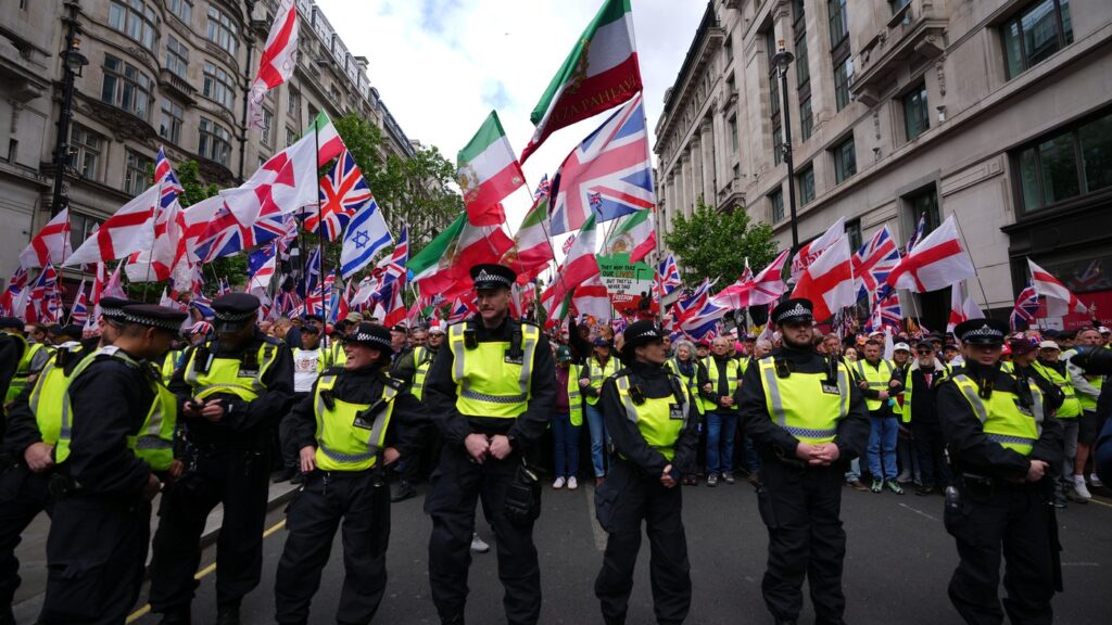 Police forces stand in front of the far right Unite the Kingdom march in London, Saturday, May 16, 2026.(AP Photo/Kirsty Wigglesworth)