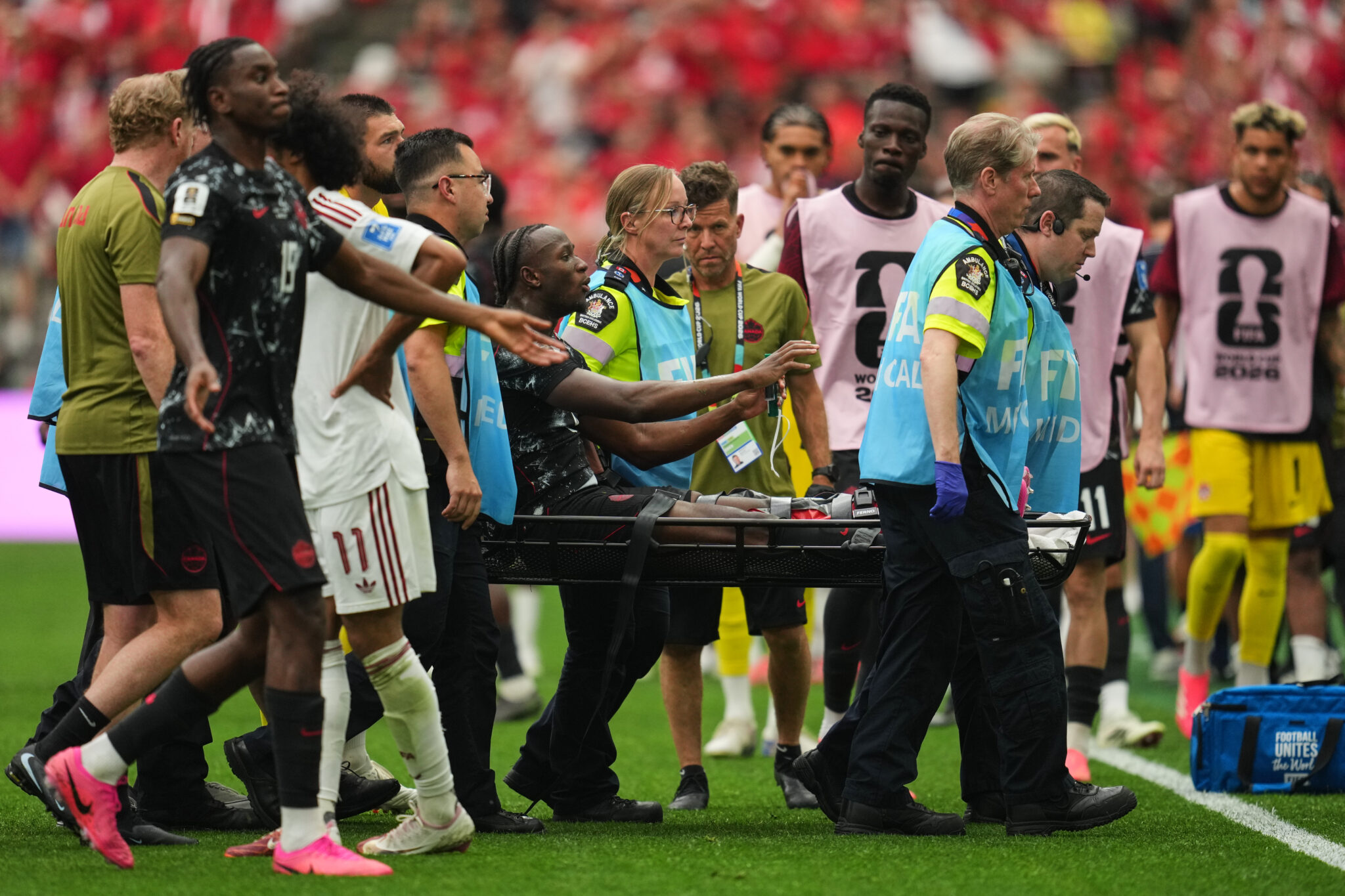 Ismaël Koné, center, is carried off the field after receiving medical attention during the group-stage World Cup match against Qatar in Vancouver, British Columbia, on Thursday, June 18, 2026. (AP Photo/Abbie Parr)
