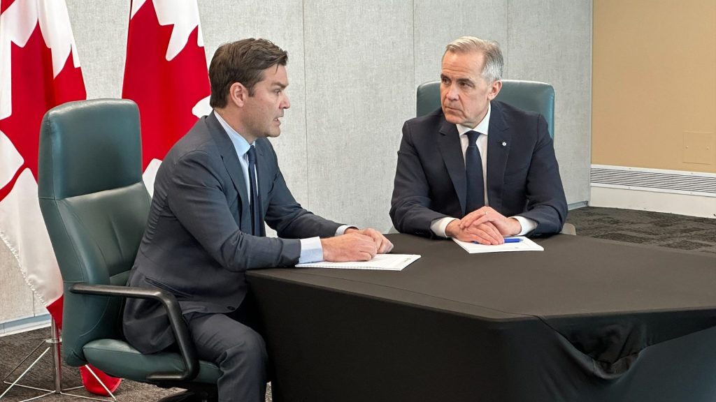 Former Conservative MP Matt Jeneroux (left) sits with Canadian Prime Minister Mark Carney in Edmonton on Feb. 18, 2026, hours after it was announced the Edmonton MP was crossing the floor to the Liberals. (Matt Battochio, CityNews)