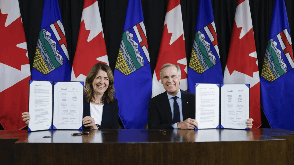 Prime Minister Mark Carney, right, signs an MOU with Alberta Premier Danielle Smith in Calgary, Alta., Thursday, Nov. 27, 2025. THE CANADIAN PRESS/Jeff McIntosh